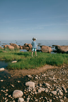 Man in virtual glasses on seashore