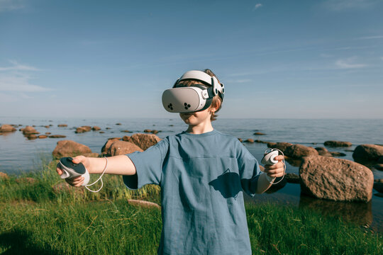 Child in virtual glasses in nature close-up