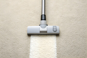 Vacuum cleaner cleaning a beige carpet leaving a clean path on transparent background
