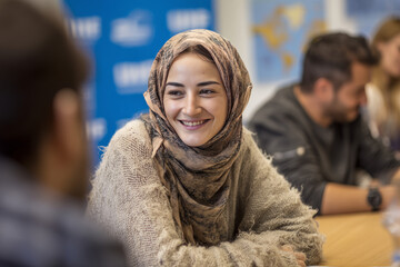 Refugees participating in a job interview training session Volunteers role play as interviewers