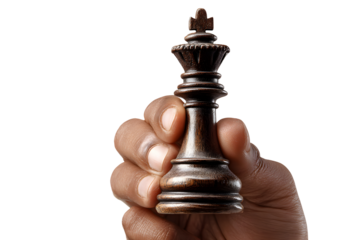 Hand holding a black king chess piece isolated on transparent background