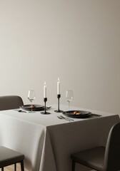Minimalist dining table setup with candles and elegant black tableware