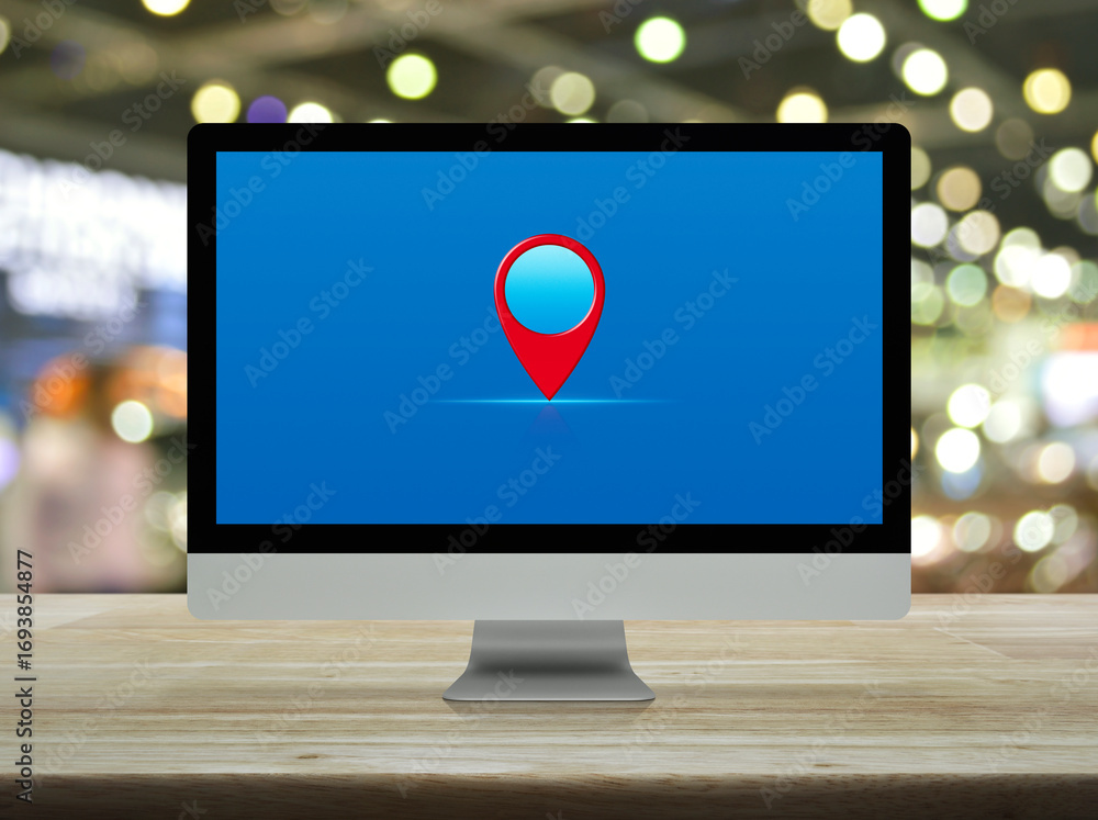 Aufkleber map pin point location button on modern computer monitor screen on wooden table over blur light and 