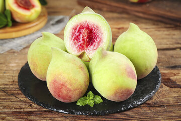 Fresh Ripe Guavas with Pink Flesh on Slate Plate - Tropical Fruit on Wooden Background