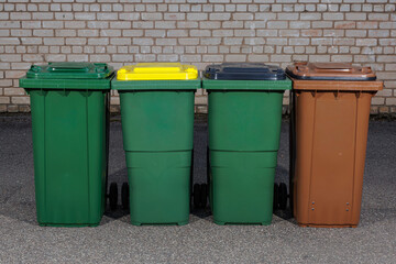 Four Outdoor Recycling and Waste Bins with Color Lids