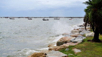 Splashing sea surf hitting rocks on the beach