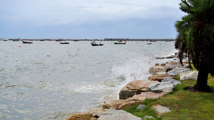 Splashing sea surf hitting rocks on the beach