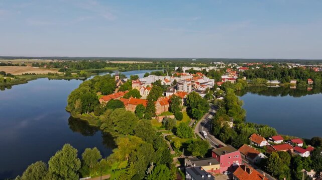 Low aerial shot of Sztum Castle and rooftops captured with forward drone motion