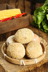 Golden Flour Coated Eggs in Bamboo Basket with Fresh Vegetables on Wooden Table