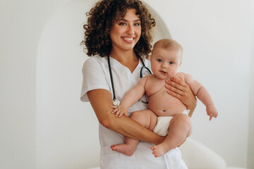 Professional medical worker. Female doctor is with newborn baby indoors