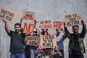 Group Of Diverse People Holds Up Protest Signs