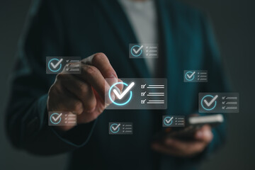 Businessman managing digital checklist with virtual interface on smartphone, representing task...