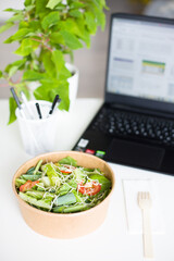 Fresh Salad Bowl by Computer on Office Desk