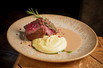 Savor tender beef with creamy potatoes and rich sauce, all elegantly plated