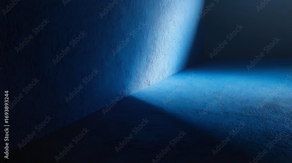 Aufkleber a corner of a textured blue wall illuminated by a bright light, casting a deep shadow and creating a