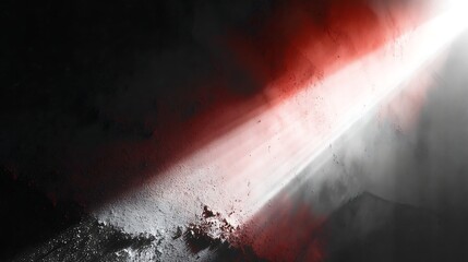 Dramatic spotlight illuminating a dark, textured surface with a red hue, creating a mysterious and intense atmosphere