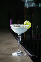 A beautifully crafted cocktail awaits at the bar, inviting guests to savor its flavors