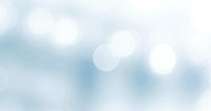 Abstract blurred background with soft blue and white tones bokeh effect, radiating luminous dreamy glow that conveys a calm airy atmosphere with elegance.