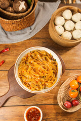 Cold Sweet Potato Vermicelli Noodles with Mixed Vegetables and Steamed Buns on Rustic Wooden Table