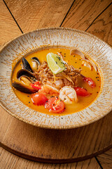 Savory seafood soup with shrimp, mussels, vibrant tomatoes, and fresh herbs