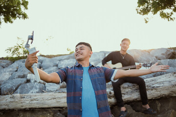 Vlogger Playing Guitar Outdoors Recording Content