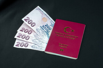 turkish passport and turkish money, liras on black background