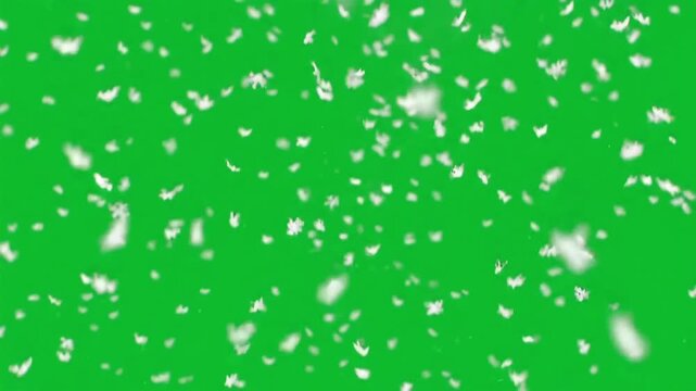 Gentle Flurry of Winter Snow: A gentle snowfall drifts gracefully against a vibrant green backdrop, creating a sense of peacefulness and tranquility, ideal for conveying the beauty of winter.