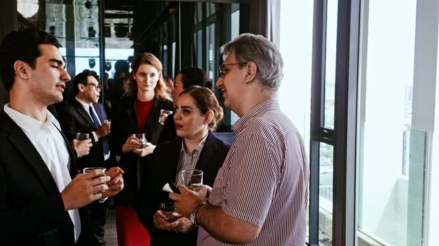 Professionals in business attire chat by large windows with drinks at office event. Corporate mixer blends networking, teamwork, meeting, seminar, workshop, conference, reception, and meetup.