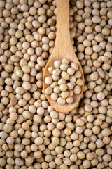 Raw dehydrated soybeans texture background top view.