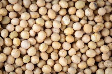 Raw dehydrated soybeans texture background top view.