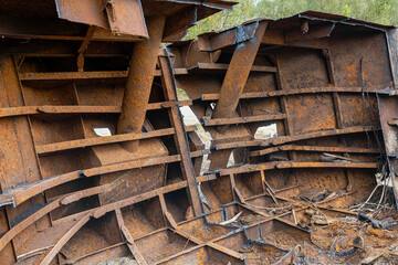 Rusty remnants of an old structure showcase decay and nature's reclamation over time