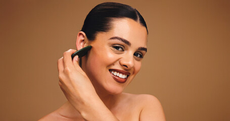Woman, gua sha and skincare portrait in studio, lymphatic drainage or antiaging beauty. Mockup...
