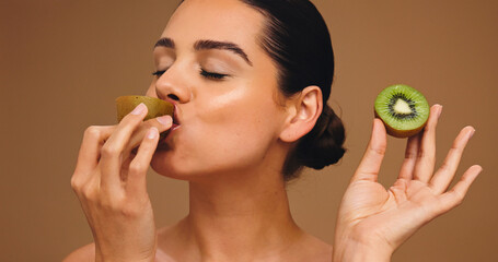 Beauty, kiwi and eating with woman in studio for vitamin c, nutrition and antioxidants glow. Self...