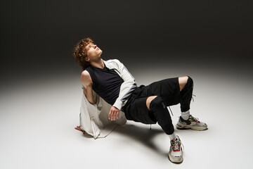 Young curly dancer expresses freedom in dynamic studio movement