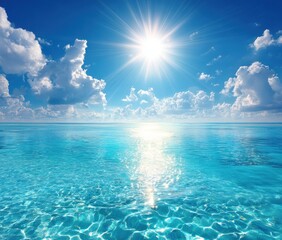Brilliant sun shines over a tranquil turquoise sea reflecting light, under a vivid blue sky dotted with fluffy white clouds