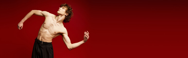 Curly haired dancer expresses movement and grace in vibrant studio setting