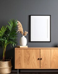 A mockup frame placed on a cabinet in a living room interior against an empty dark wall background