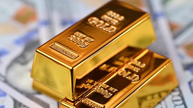 gold bars with dollar bills