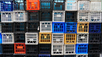 Colorful arrangement of plastic crates stacked together in an urban setting during daylight hours