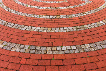 Red cobblestones arranged in round. Floor background