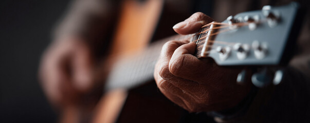 Closeup on hands skillfully playing an acoustic guitar, embodying passion, experience, and musical artistry. Perfect for themes of music, practice, or hobbies.