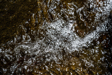 Water Bubbles and Ripples on Rocky Surface