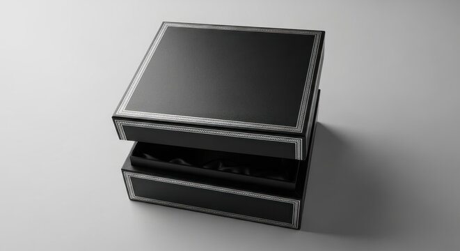 A black square gift box with a silver border, open to reveal its interior