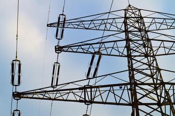 Electricity Price Increase Concept with Power Lines and Rising Bills.  Photo of a tall metal...