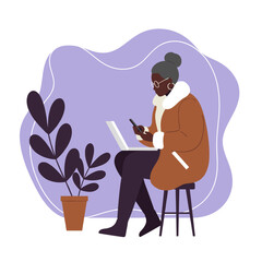 A senior Black woman uses a laptop and smartphone, illustrating digital literacy and active modern living. Great for themes of remote work and connectivity.