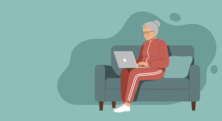 Elderly woman in a tracksuit comfortably using a laptop on a sofa at home, representing senior technology adoption, modern living, and digital literacy.