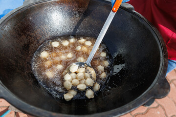 Deep frying sweet dumplings is best done in a traditional wok for authentic results