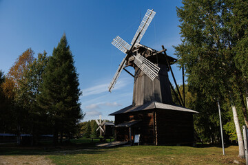 A Beautiful Traditional Windmill Nestled in the Midst of Lush and Vibrant Nature