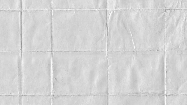 Textured folded paper surface showing creases and lines in neutral grayscale for backgrounds and design