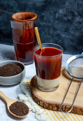Traditional Thai tea brewing. Hot orange tea with condensed milk.